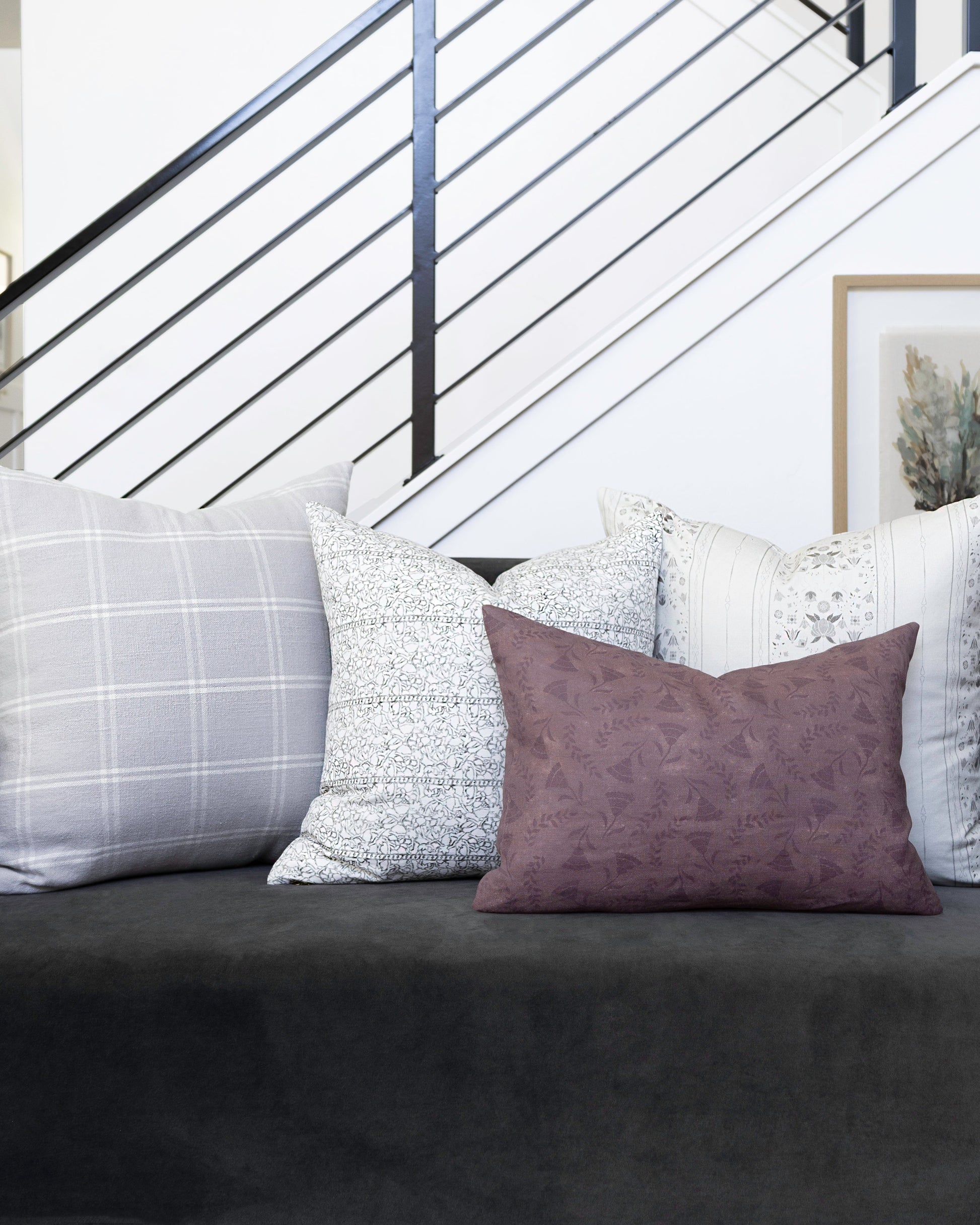 Gray sofa with patterned cushions in a home setting
