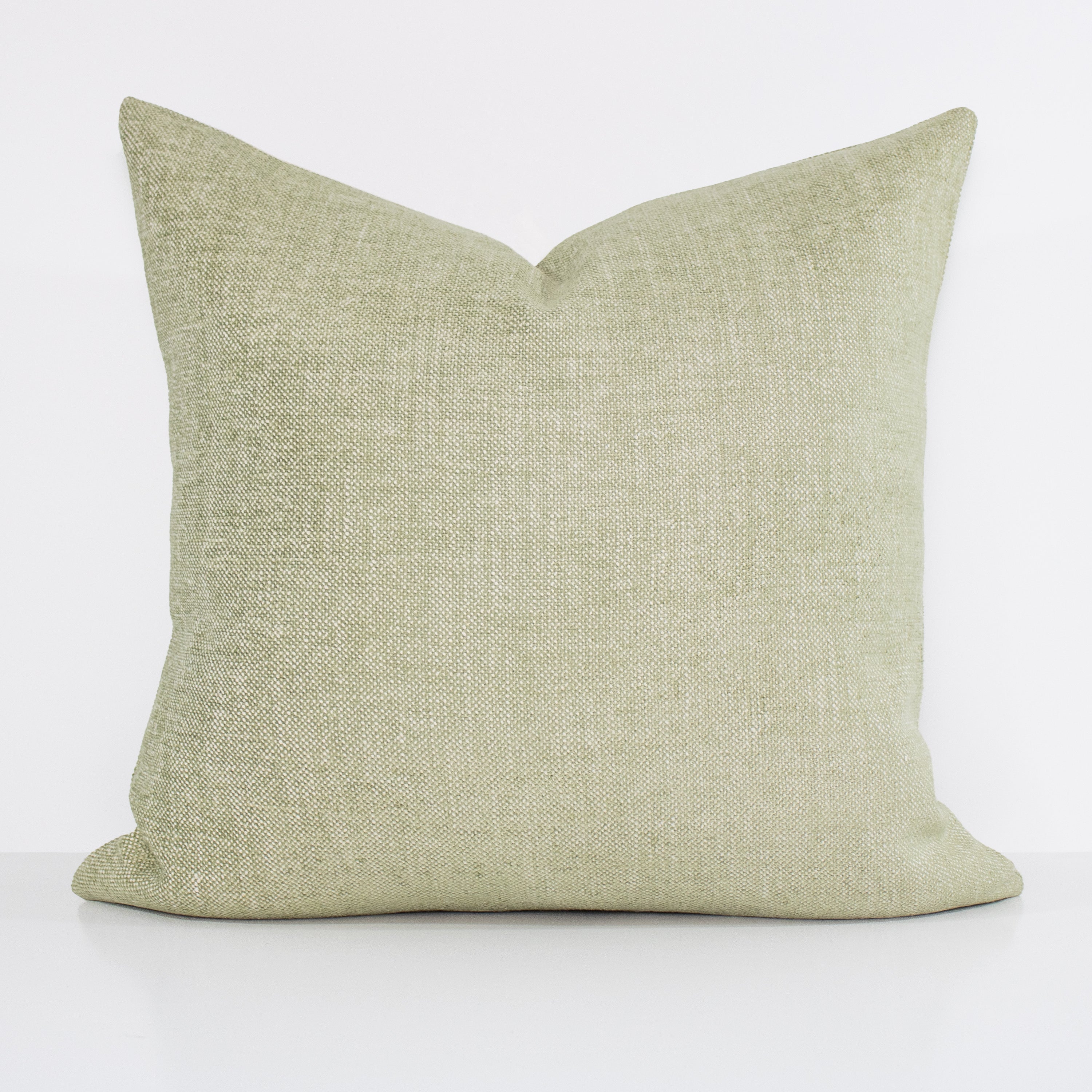 Green textured pillow on a white background